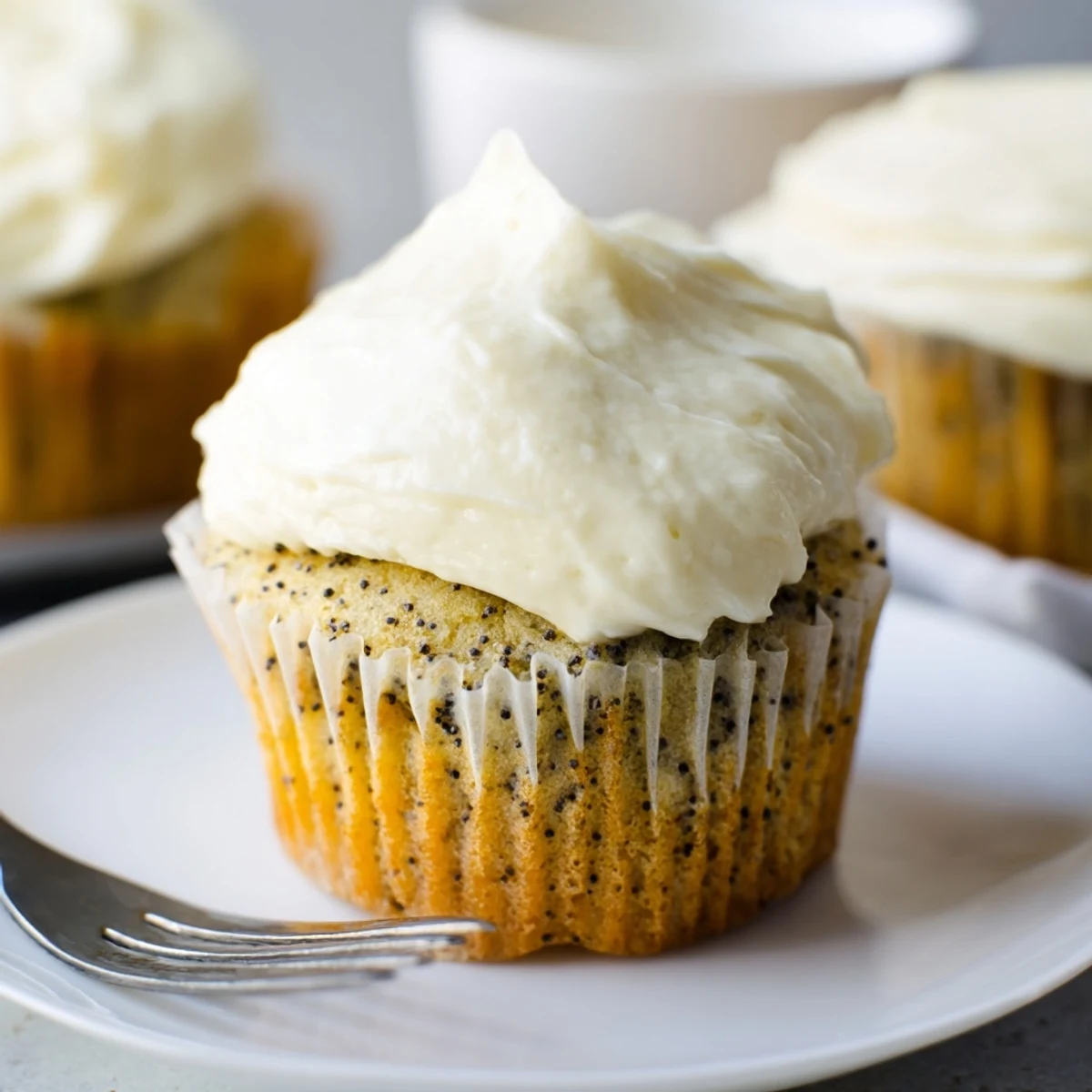 Moist homemade lemon poppy seed cupcakes with creamy lemon frosting and crunchy seeds