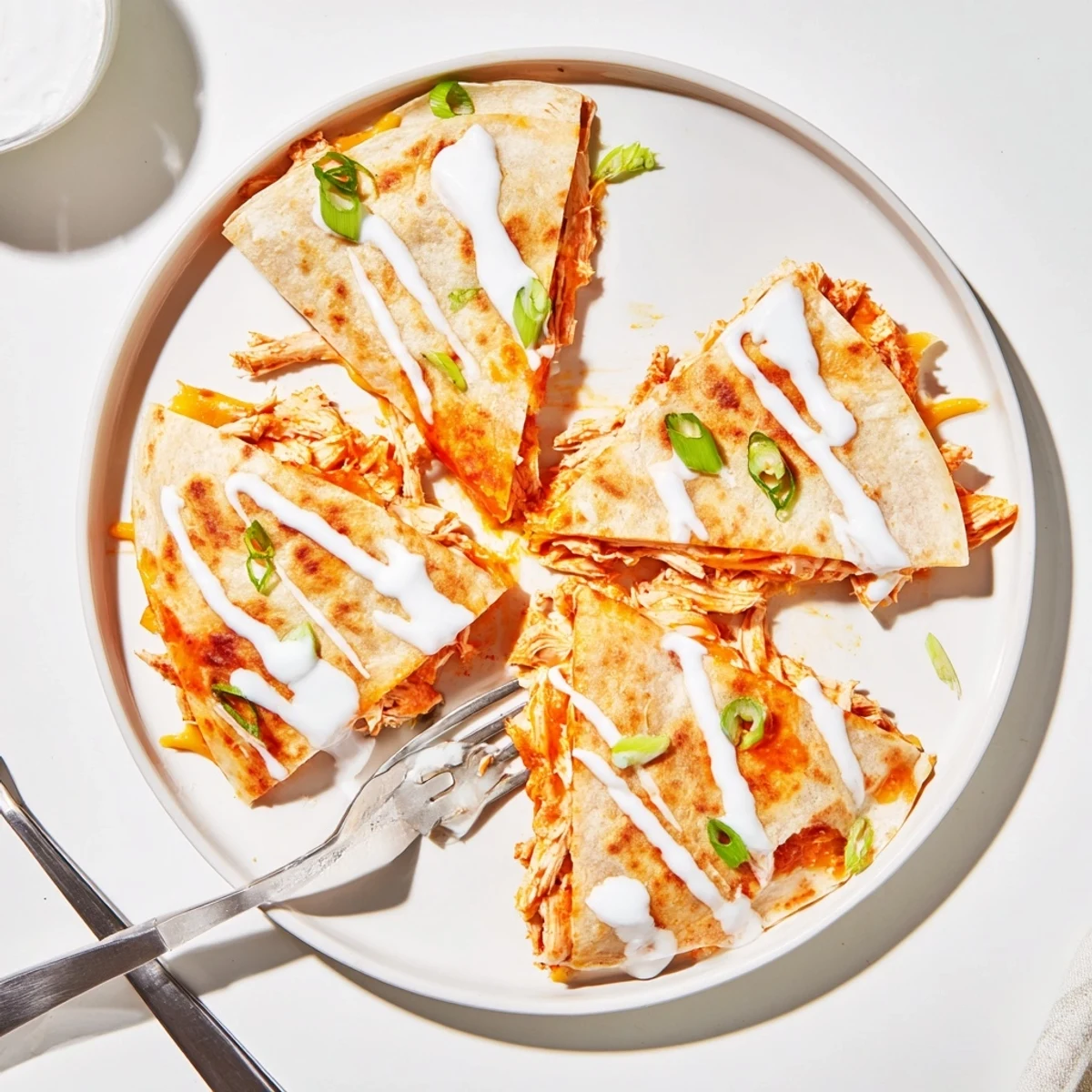 Crispy flour tortilla quesadillas stuffed with buffalo chicken finished with tangy ranch swirl