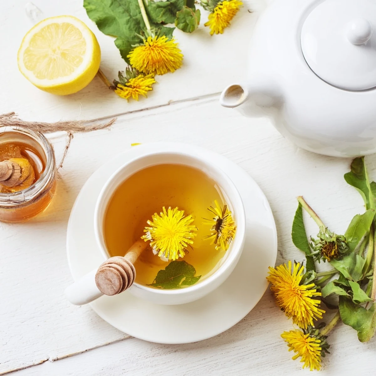 Homemade dandelion tea served with lemon wedge and honey drizzle on rustic wooden table setting