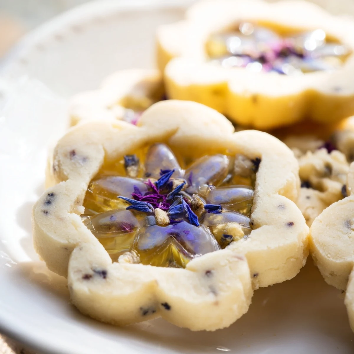 Earl Grey Stained Glass Floral Cookies showcase translucent jewel-toned candy centers with pressed violet petals
