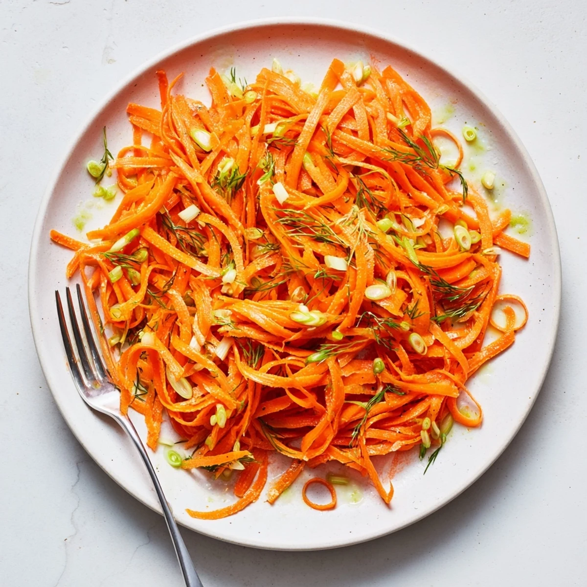 Tender carrot ribbons coated in zesty lemon dill marinade for a refreshing Marinated Lemon Dill Carrot Salad