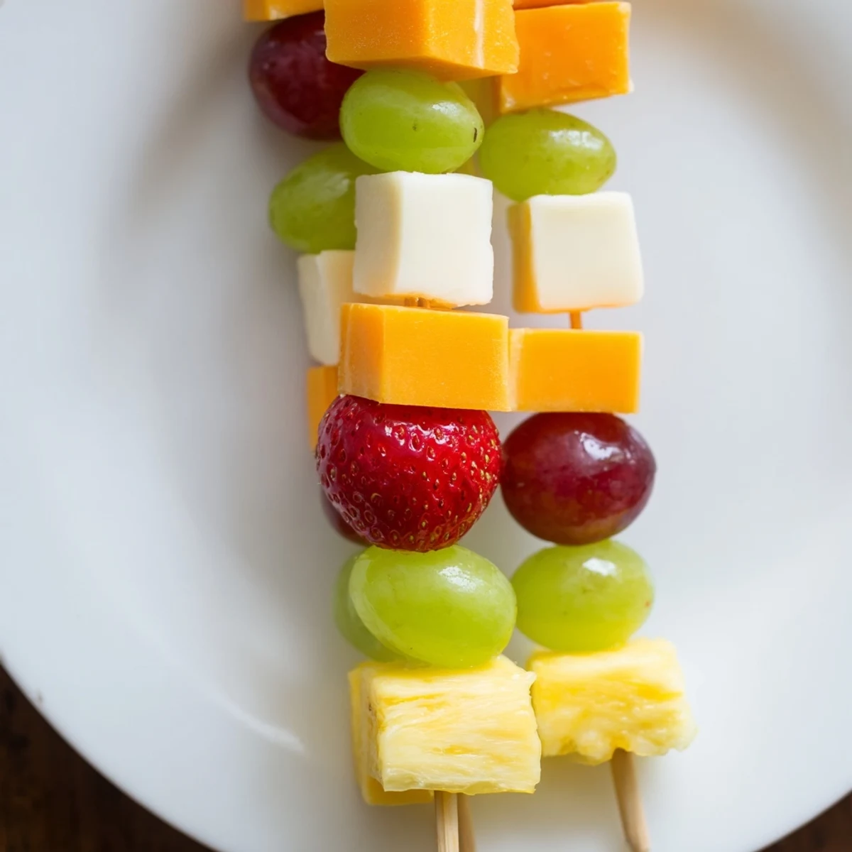 Fresh fruit and cheese kabobs featuring alternating cubes of creamy mozzarella and ripe red grapes