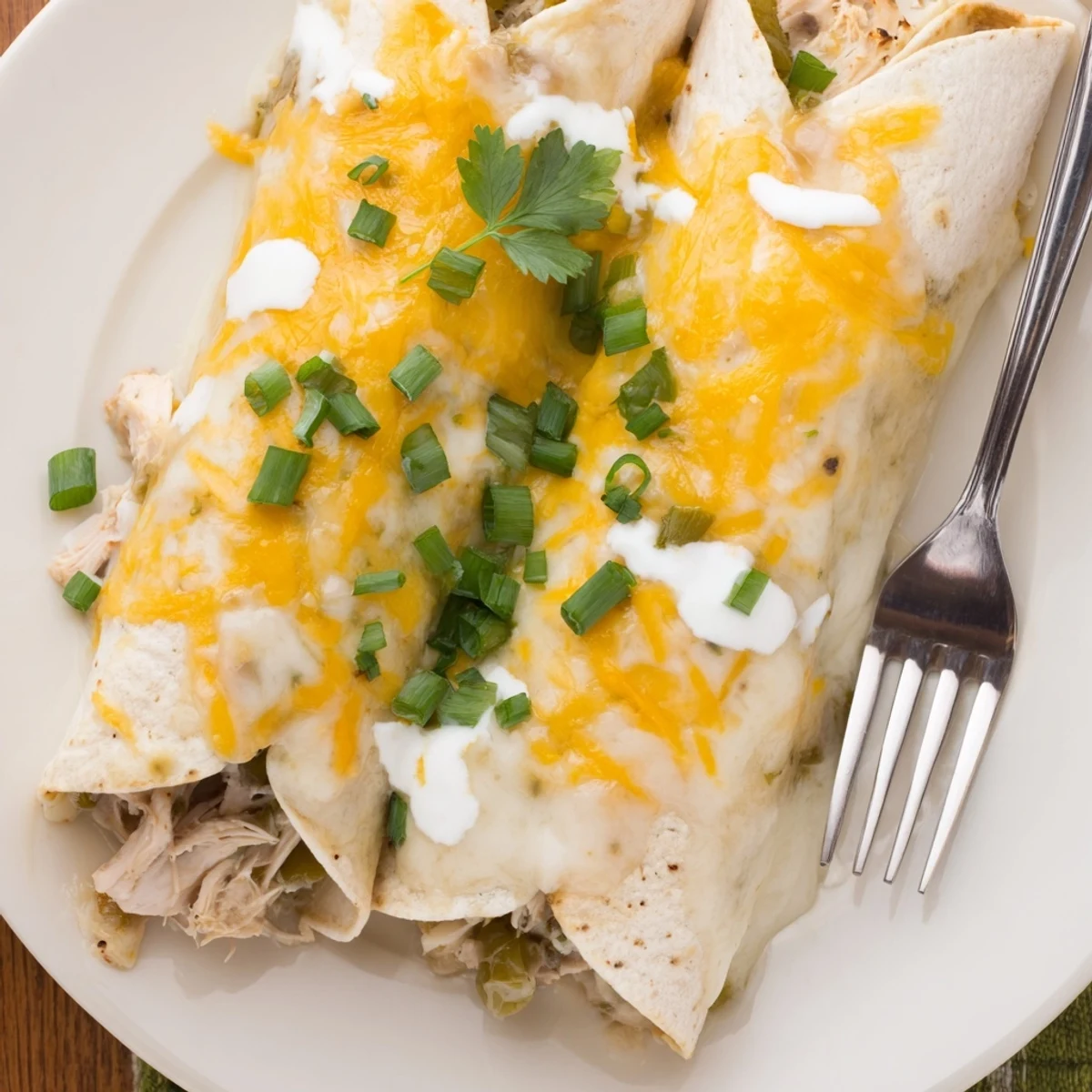 Family-style Creamy White Chicken Enchiladas in baking dish, velvety sauce, scallions