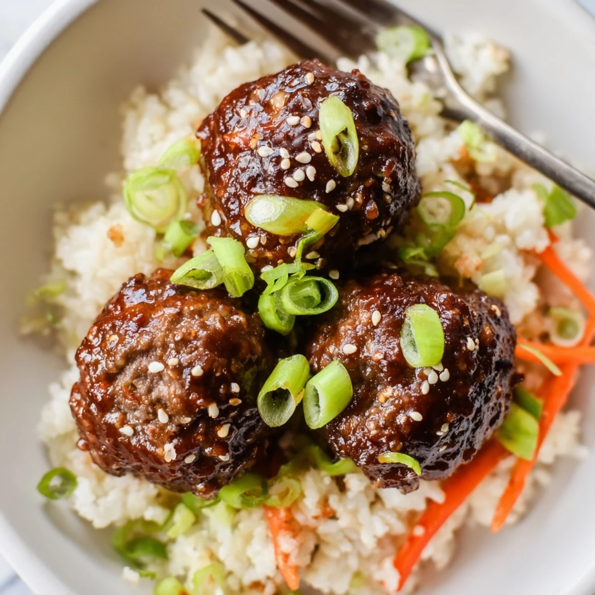 Plated Hello Fresh Firecracker Meatballs with crisp sauteed vegetables and sesame garnish