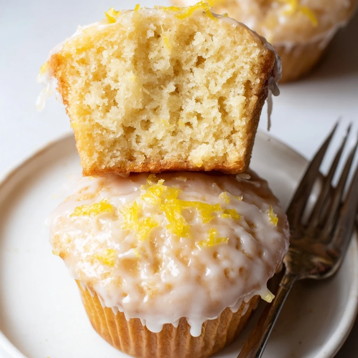 Stacked Glazed Lemon Ginger Muffins drizzled with sweet lemon glaze, served with tea