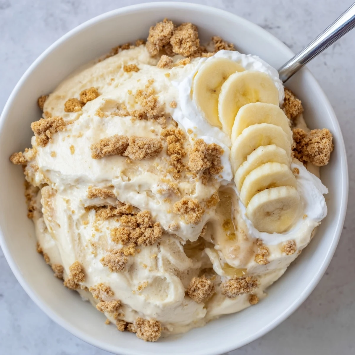 Homemade Ninja Creami Banana Cream Pie Ice Cream served in bowls, banana garnish