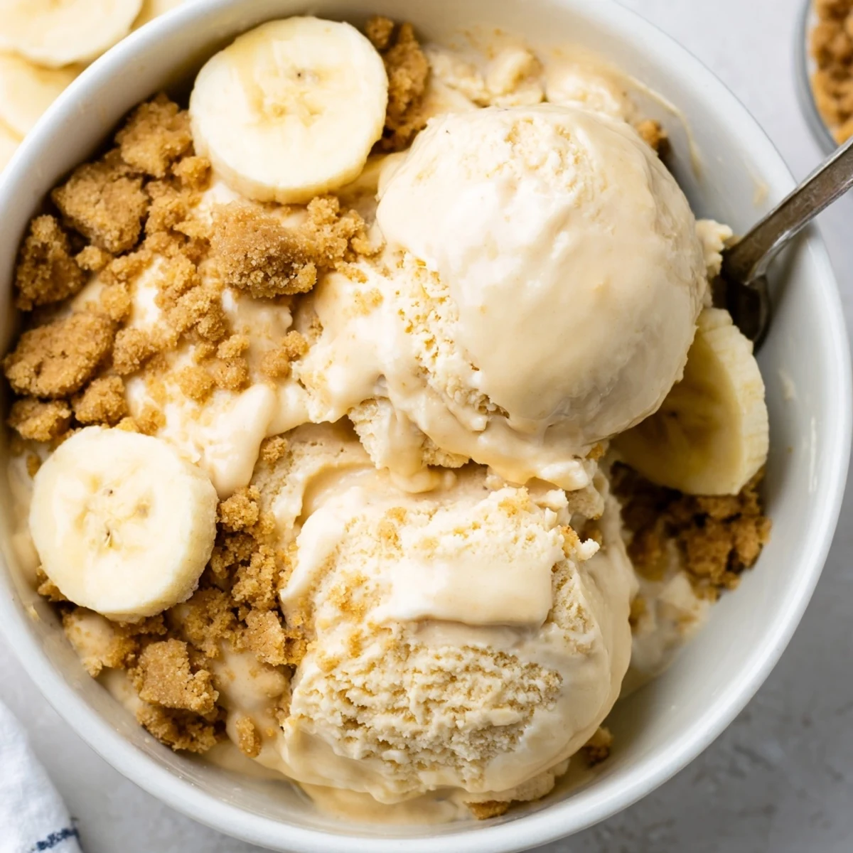 Chilled Ninja Creami Banana Cream Pie Ice Cream topped with fluffy whipped cream