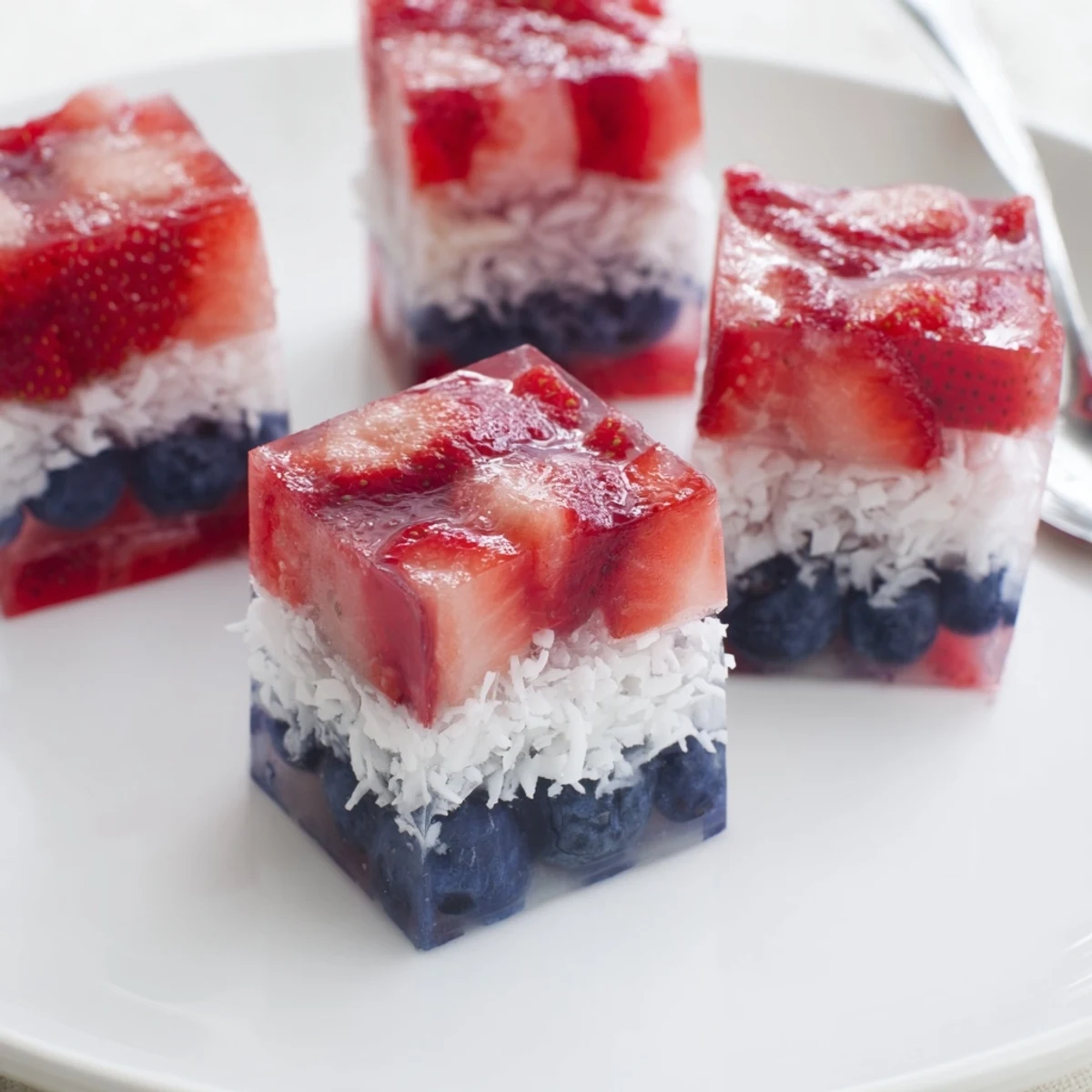 Close-up of homemade Red White And Blue Ice Cubes Recipe in sparkling lemonade.