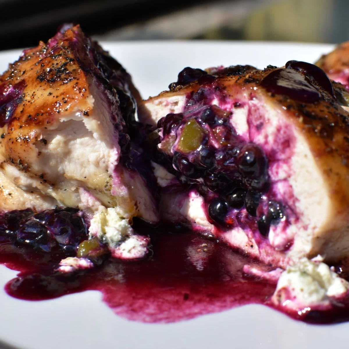 Plate of sweet spicy blackberry stuffed chicken breast with roasted vegetables and wild rice