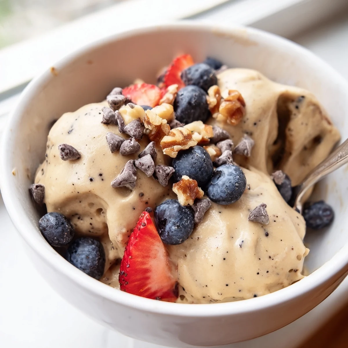 Dairy-free banana nice cream with smooth swirl texture served in a glass dessert dish