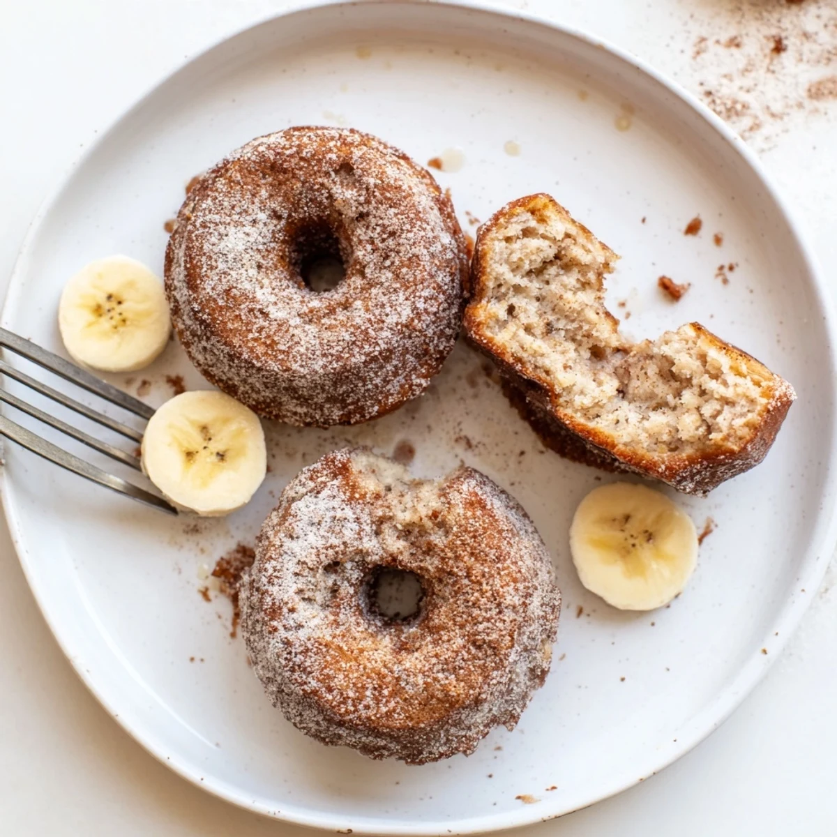 Freshly baked Banana Donuts dusted with cinnamon sugar, perfect breakfast snack