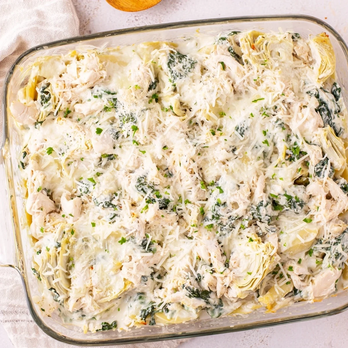 Golden bubbly Spinach Artichoke Chicken Casserole fresh from the oven with melted cheese topping