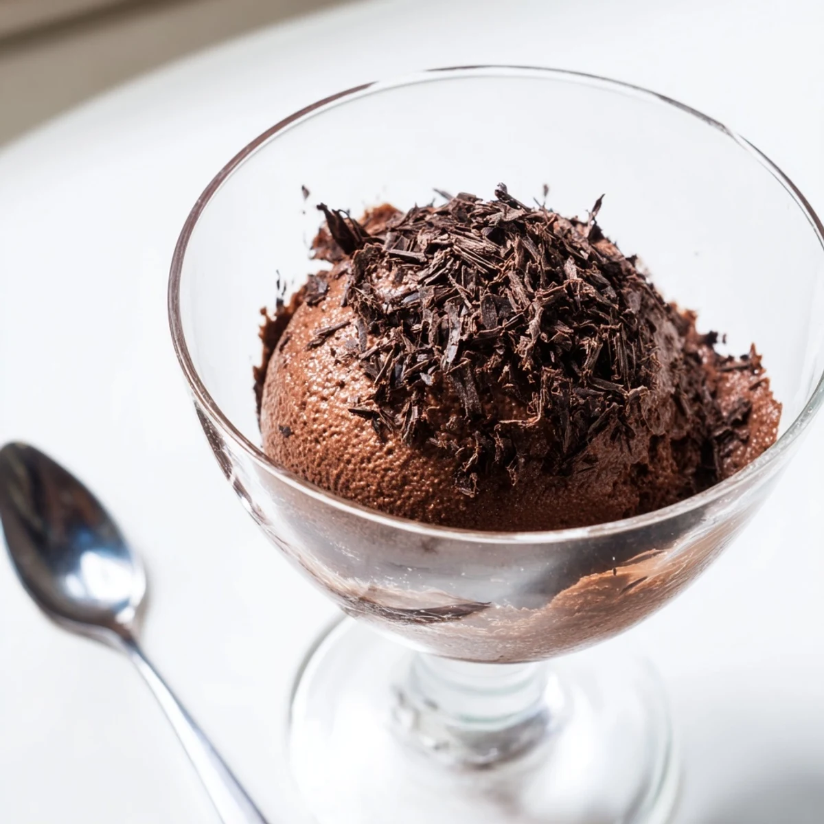 Velvety chocolate mousse served in elegant glasses topped with chocolate shavings