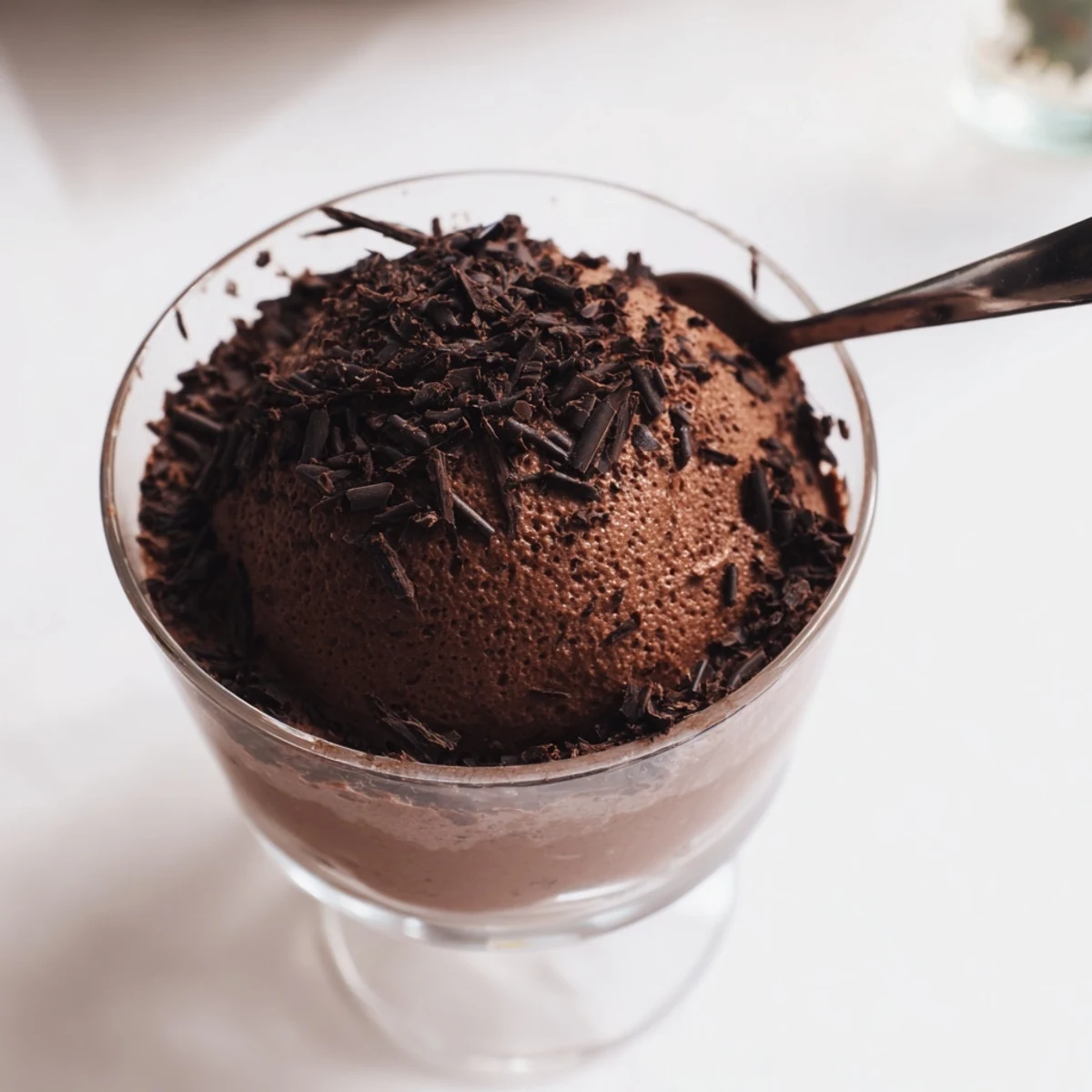 Silky chocolate mousse chilled in ramekins dusted with cocoa powder for an elegant presentation